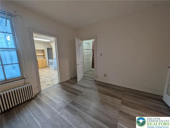 a view of a room with wooden floor and stairs
