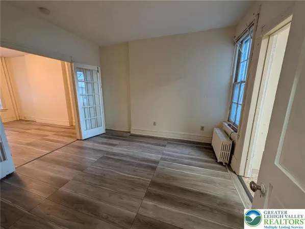 a view of an empty room with a window