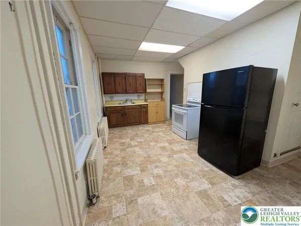 a kitchen with a refrigerator and a stove