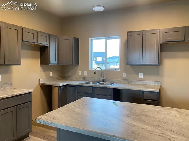 a kitchen with a sink a stove and cabinets