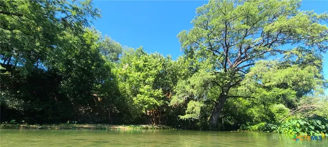 a view of a lake with houses in background