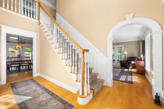 a view of a livingroom with wooden floor and furniture