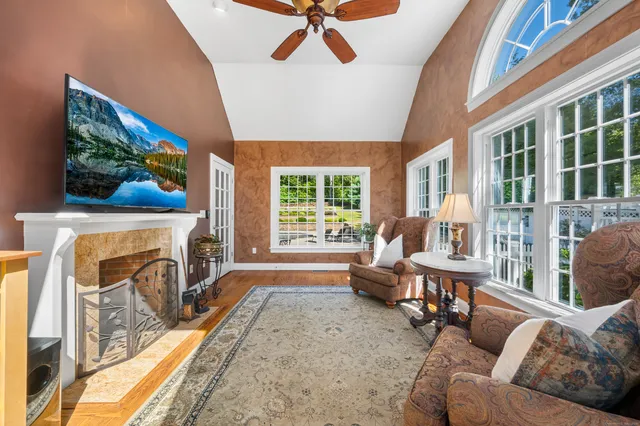 a living room with furniture a fireplace and a flat screen tv