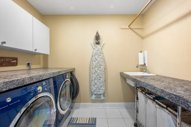 a utility room with a sink a washer and dryer