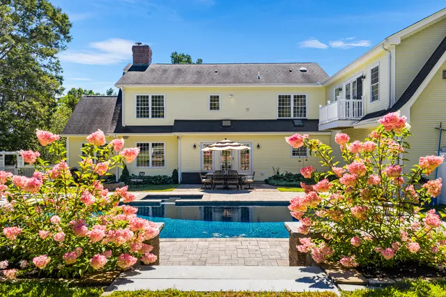 a front view of building with an outdoor space and seating
