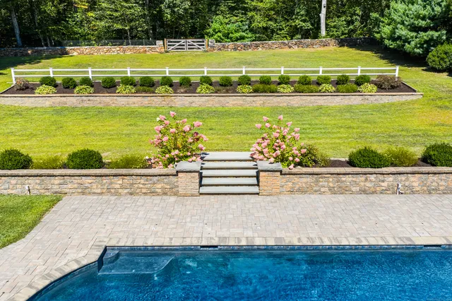 an aerial view of a house with swimming pool outdoor seating and yard