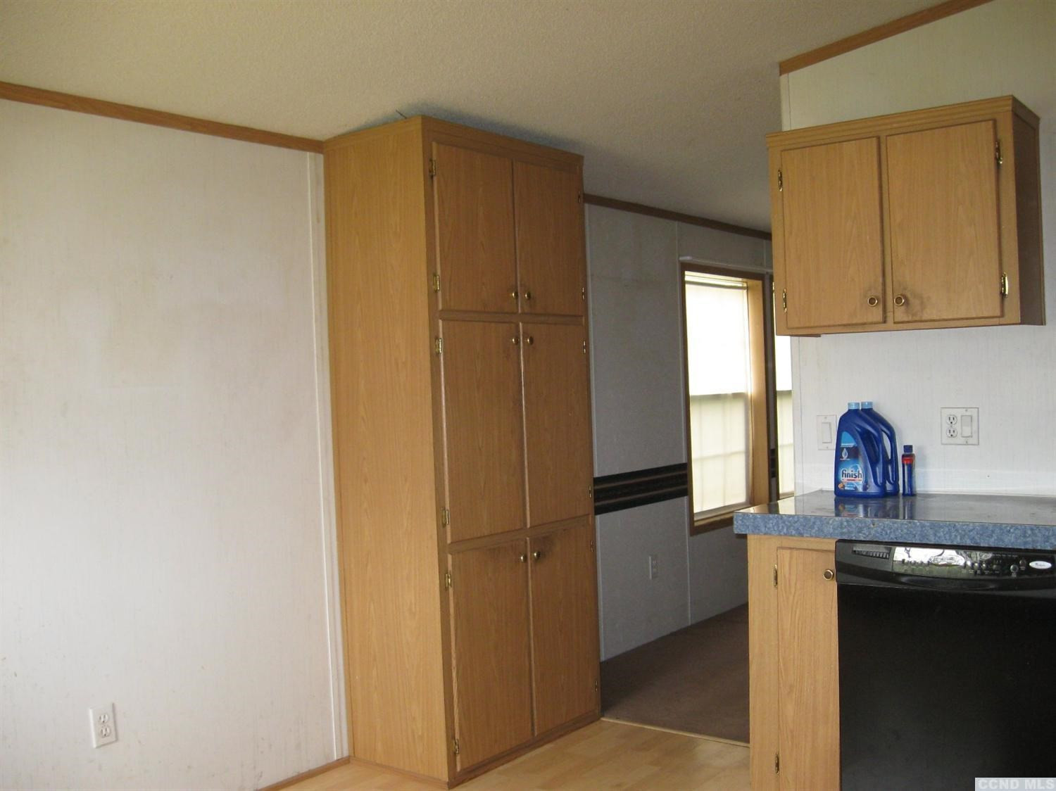 379 Cty Route Medusa, NY 12120 - Photo 7 of 10 a kitchen with granite countertop white cabinets and stainless steel appliances