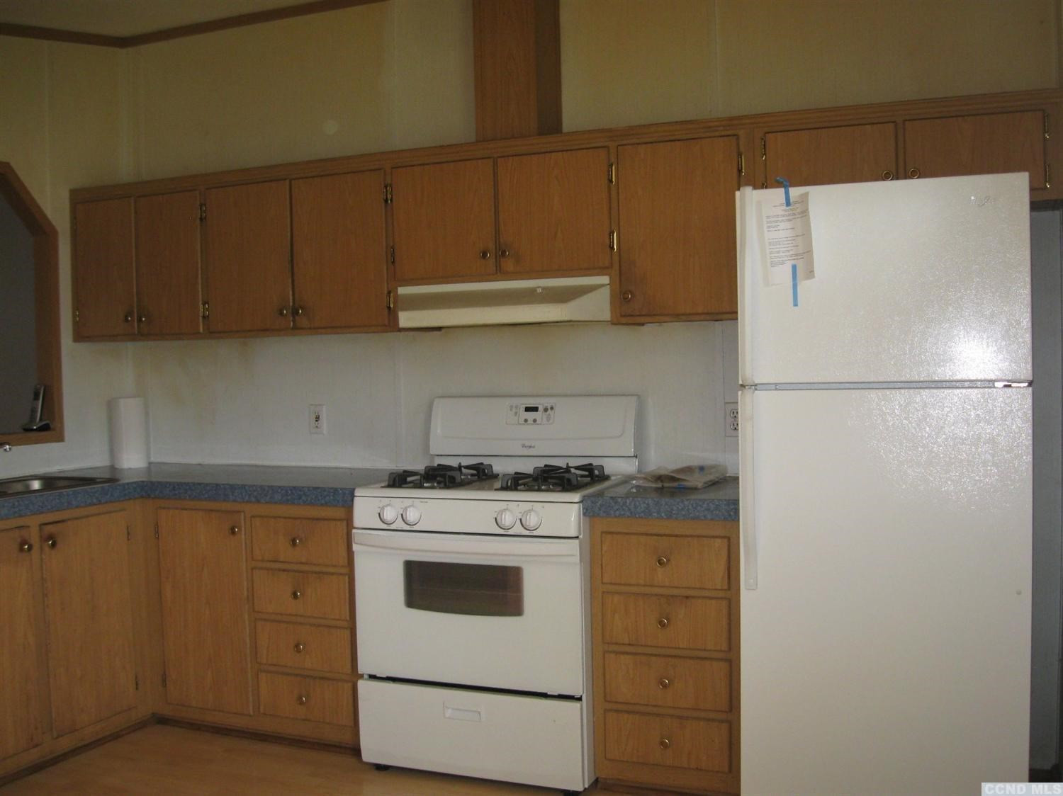 379 Cty Route Medusa, NY 12120 - Photo 8 of 10 a kitchen with a white stove refrigerator and cabinets