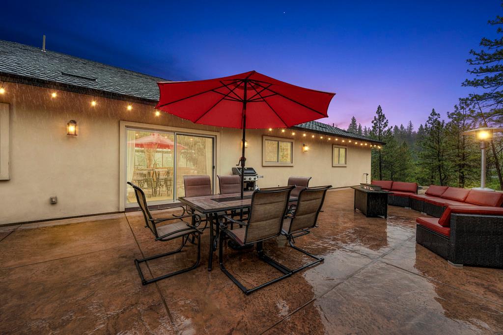 3960 Fort Jim Road Placerville, CA 95667 - Photo 51 of 64 a view of a patio with a table and chairs under an umbrella