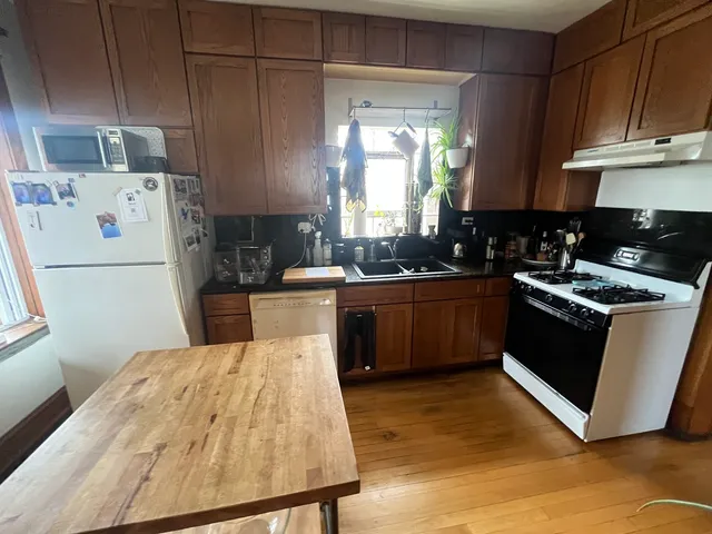 a kitchen with a sink a stove and refrigerator