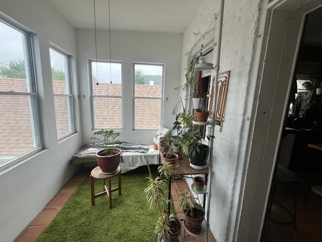 a living room with furniture and a floor to ceiling window
