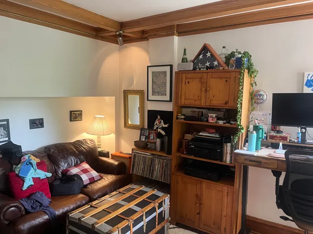 a bedroom with furniture and a flat screen tv