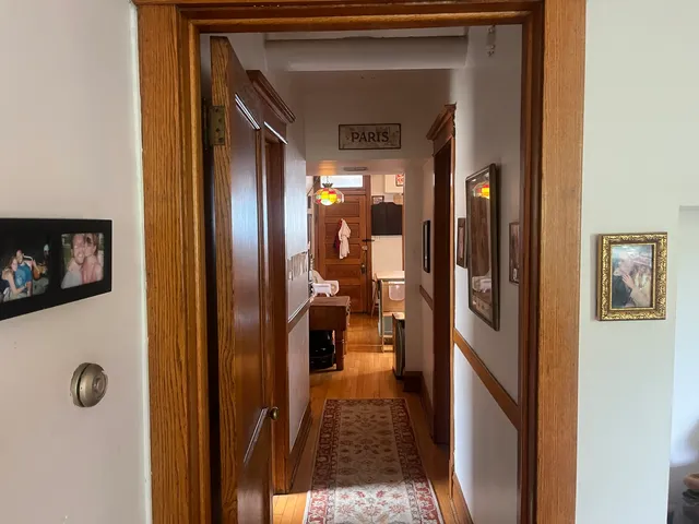 a view of a hallway view with wooden floor and staircase