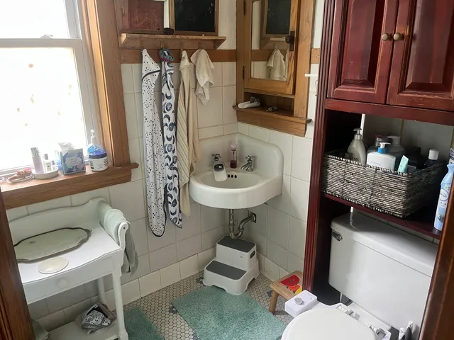 a bathroom with a sink a toilet and a mirror