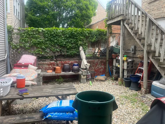 a backyard of a house with barbeque oven and outdoor seating