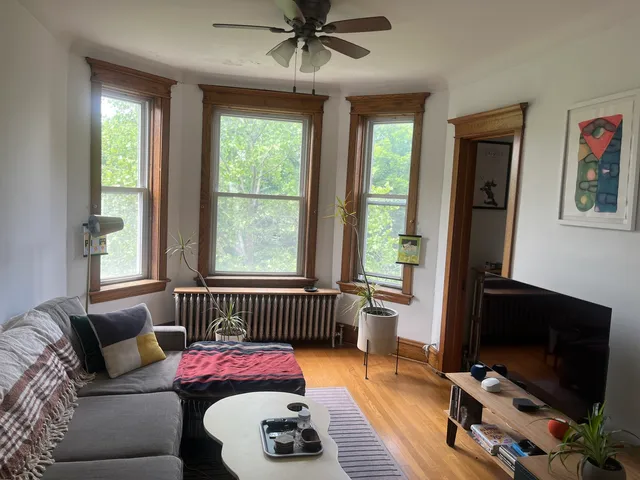 a bedroom with furniture and a window