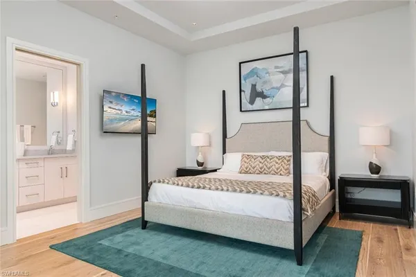 a bedroom with a bed and a painting on the wall