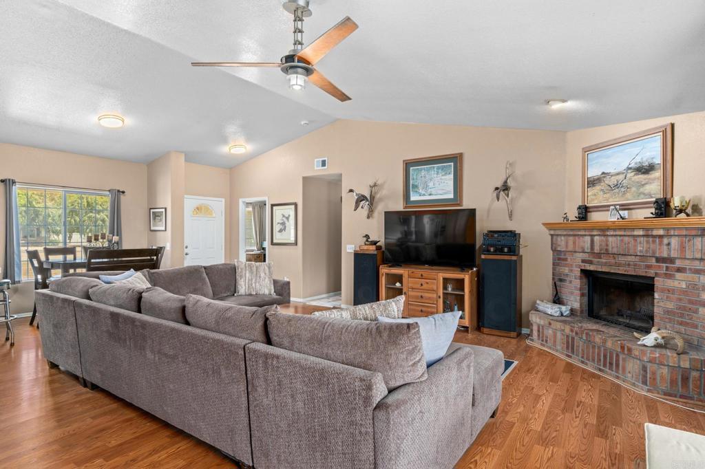272 Durgin Street Ramona, CA 92065 - Photo 7 of 46 a living room with furniture a flat screen tv and a fireplace