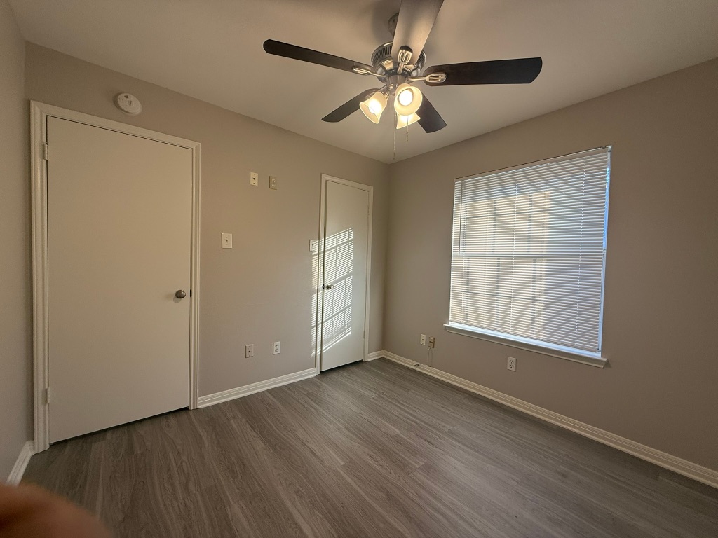 1904 Alex Avenue, Unit A Austin, TX 78728 - Photo 13 of 15 Empty room featuring dark wood-style floors and ceiling fan
