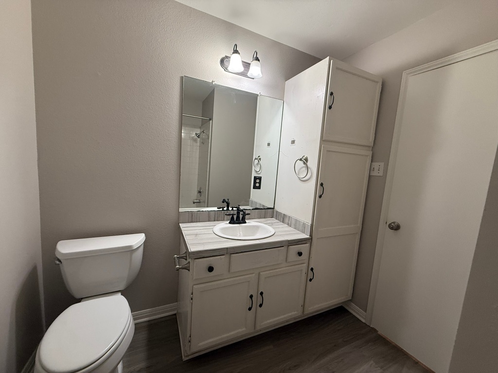 1904 Alex Avenue, Unit A Austin, TX 78728 - Photo 7 of 15 Bathroom with a shower, vanity, a textured wall, and dark wood-style flooring