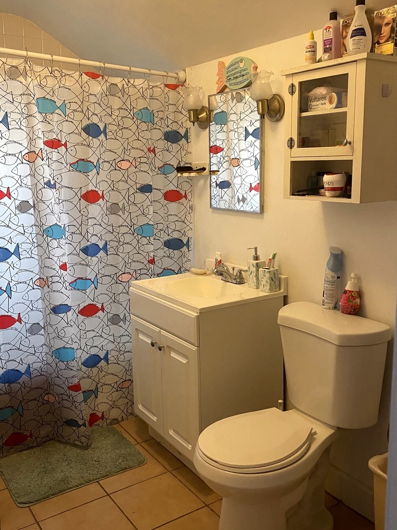 Undisclosed Address Chicago, IL 60639 - Photo 12 of 20 a white toilet sitting next to a bathroom sink