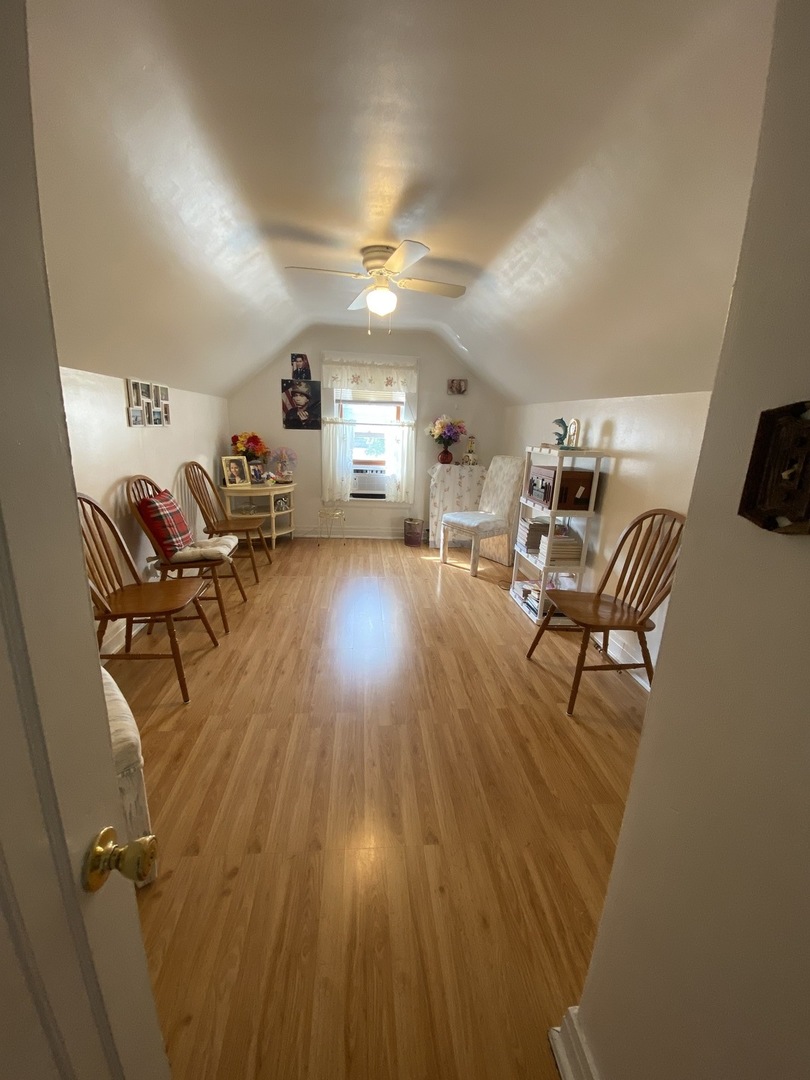 Undisclosed Address Chicago, IL 60639 - Photo 13 of 20 a living room with furniture and a wooden floor