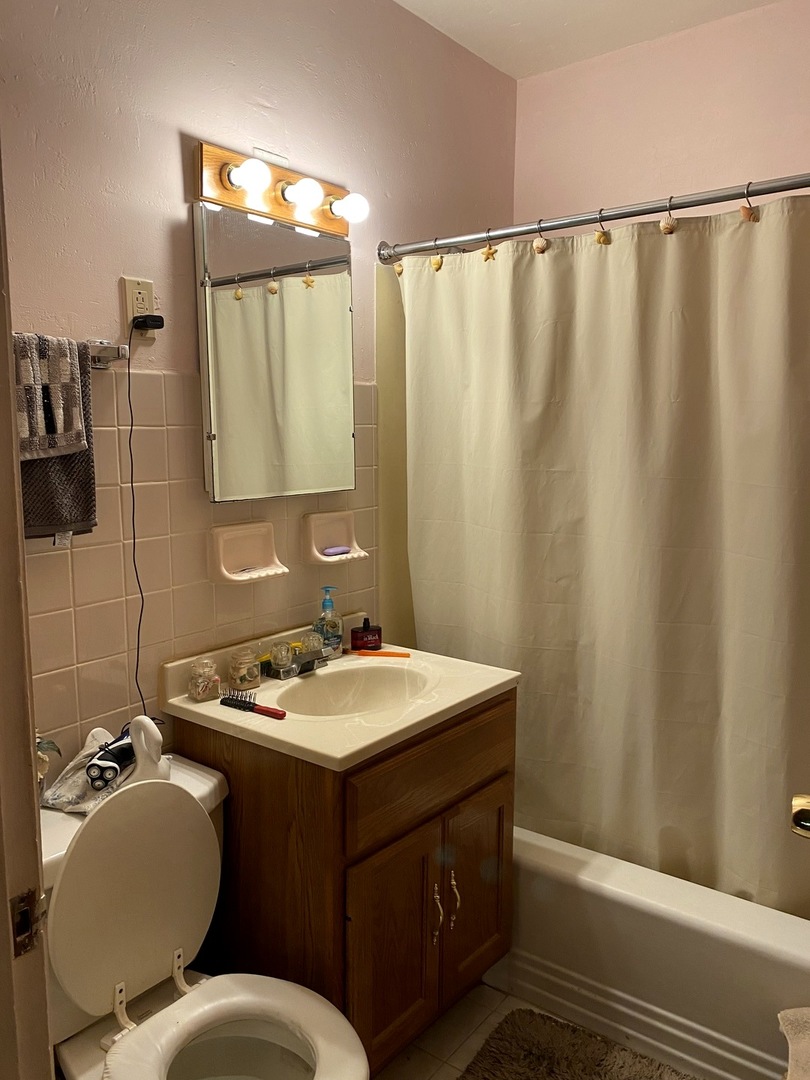 Undisclosed Address Chicago, IL 60639 - Photo 7 of 20 a bathroom with a sink and a mirror