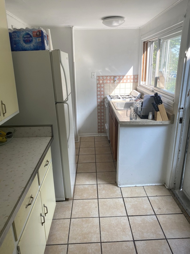 Undisclosed Address Chicago, IL 60639 - Photo 8 of 20 a kitchen with granite countertop a refrigerator and a sink