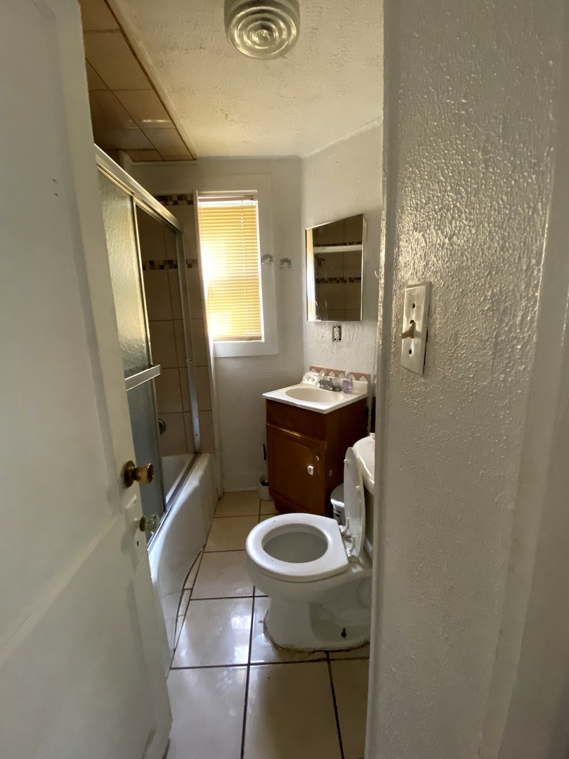 Undisclosed Address Chicago, IL 60639 - Photo 9 of 20 a bathroom with a toilet and a sink