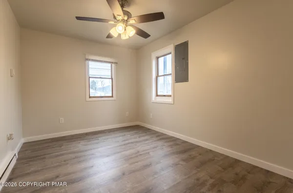 wooden floor in an empty room with a window