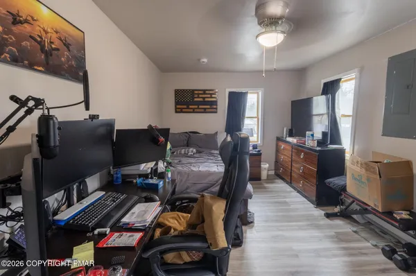 a view of a workspace with furniture and a flat screen tv