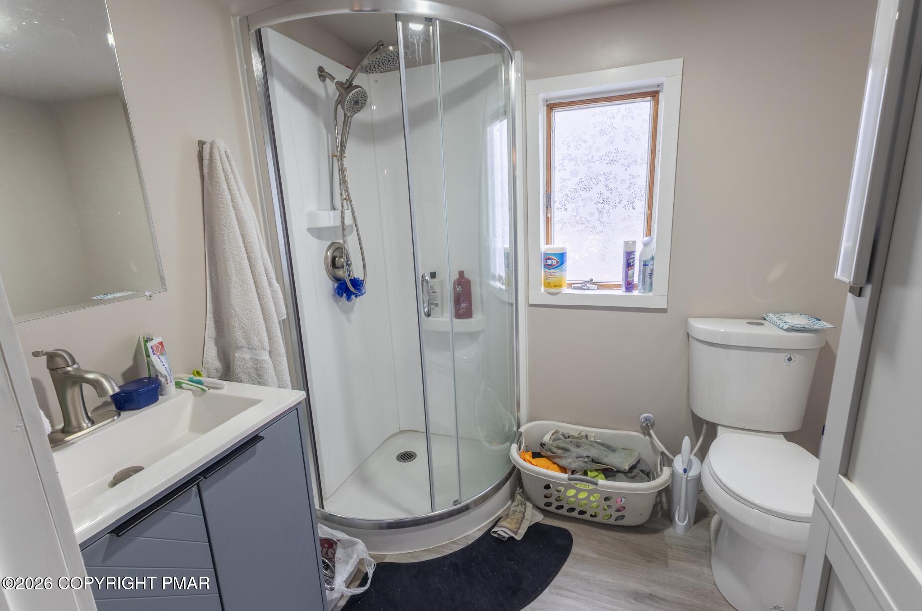 600 Rte 115 Saylorsburg, PA 18353 - Photo 18 of 26 a white toilet sitting next to a bathroom sink and a shower