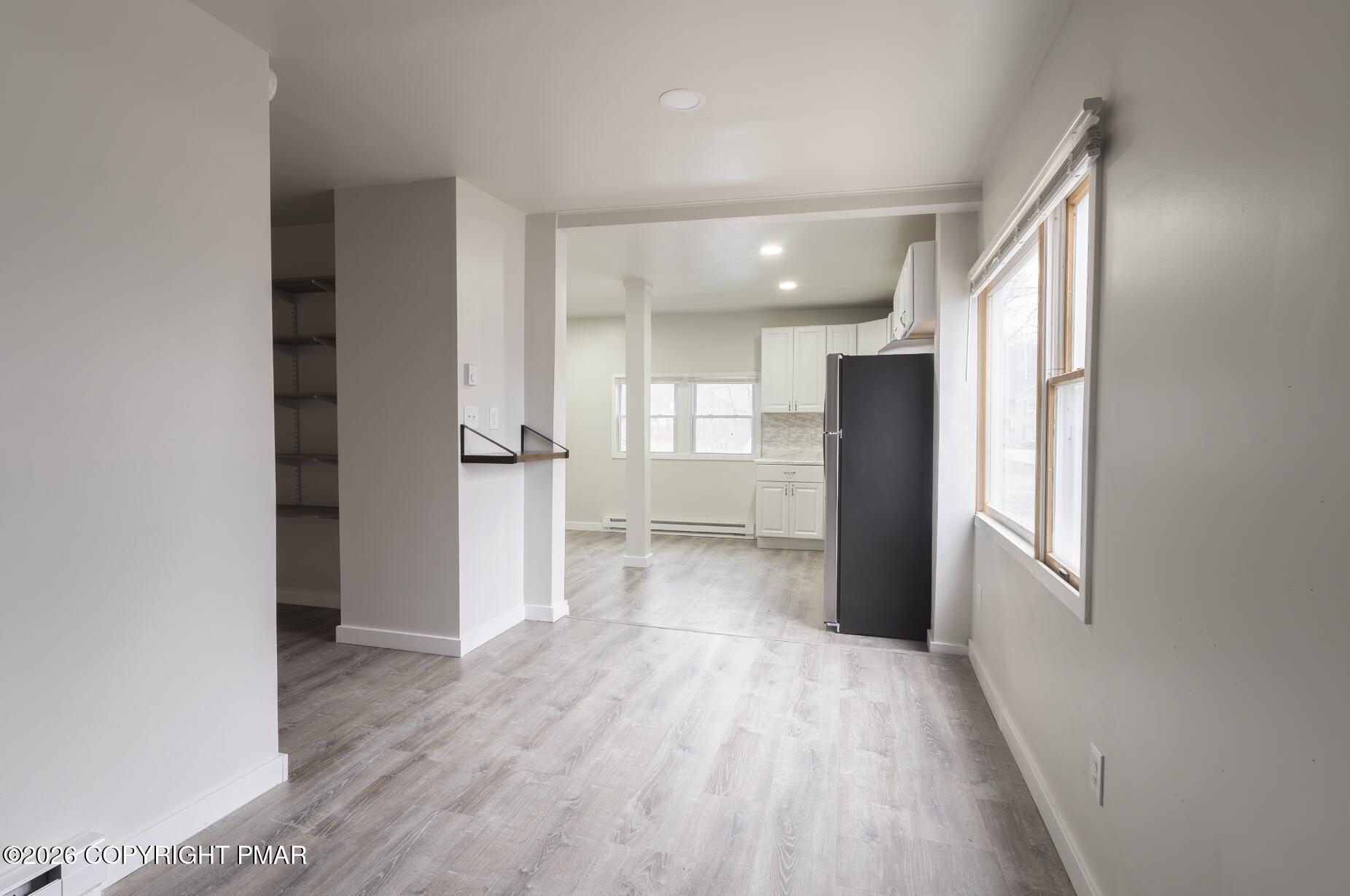 600 Rte 115 Saylorsburg, PA 18353 - Photo 4 of 26 a view of a kitchen with a refrigerator and wooden floor