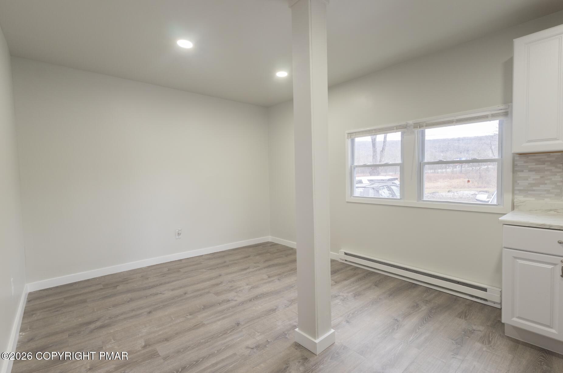 600 Rte 115 Saylorsburg, PA 18353 - Photo 7 of 26 an empty room with wooden floor and windows
