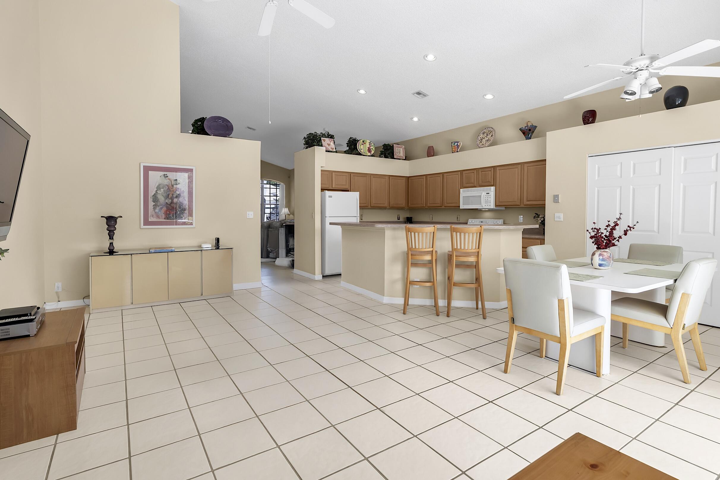 7507 Eagle Point Drive Delray Beach, FL 33446 - Photo 12 of 49 a large kitchen with a table and chairs in it