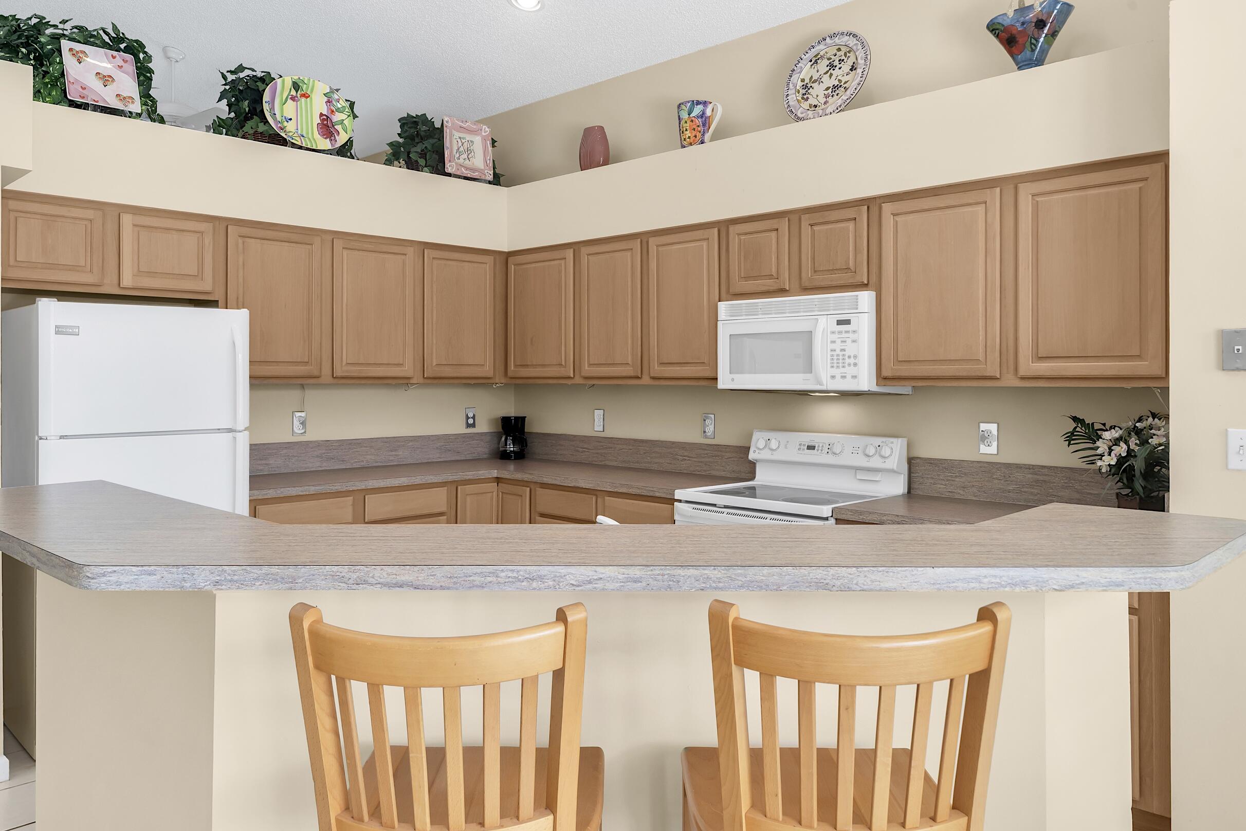 7507 Eagle Point Drive Delray Beach, FL 33446 - Photo 16 of 49 a kitchen with stainless steel appliances granite countertop a sink stove and cabinets