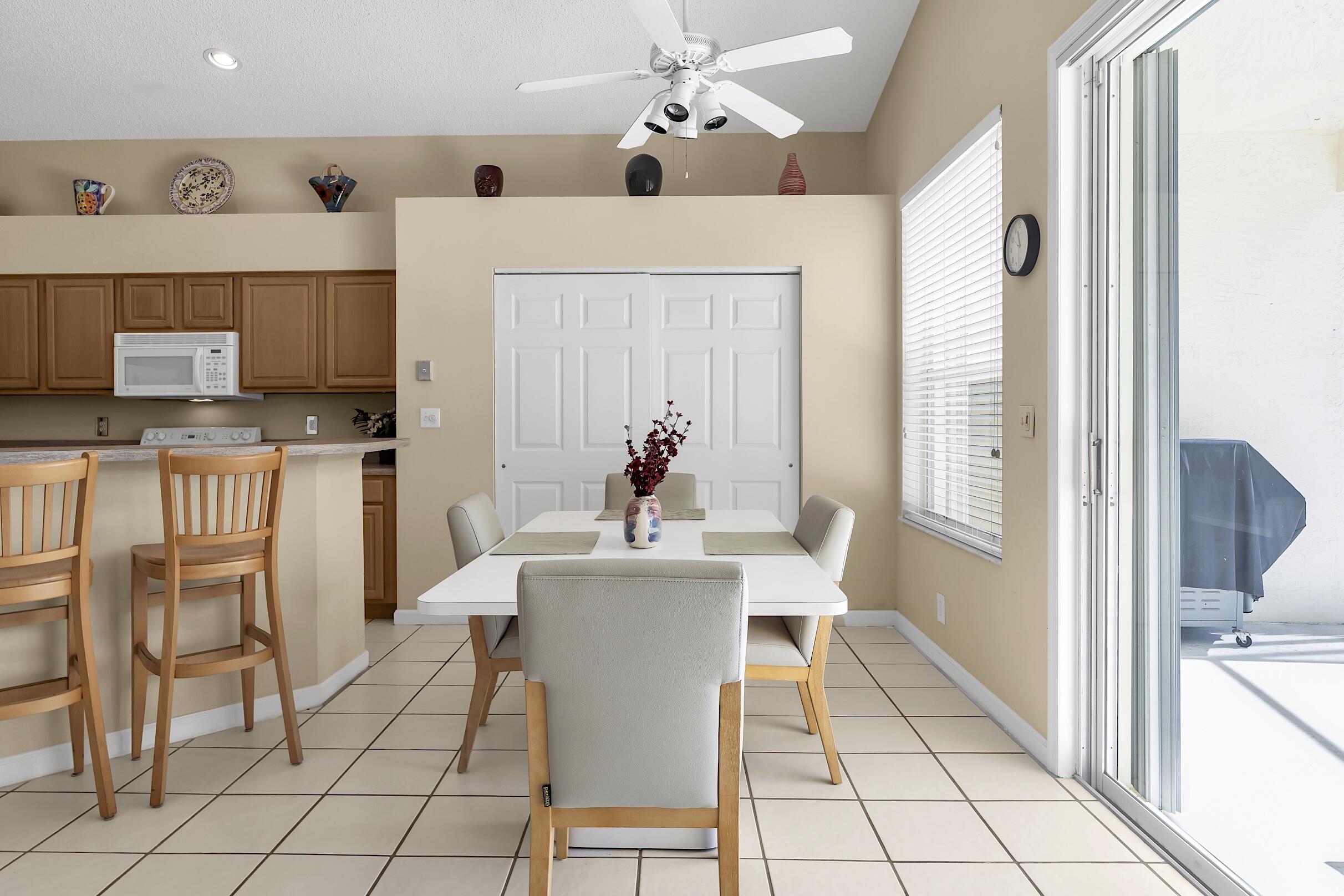 7507 Eagle Point Drive Delray Beach, FL 33446 - Photo 19 of 49 a dining room with furniture and chandelier