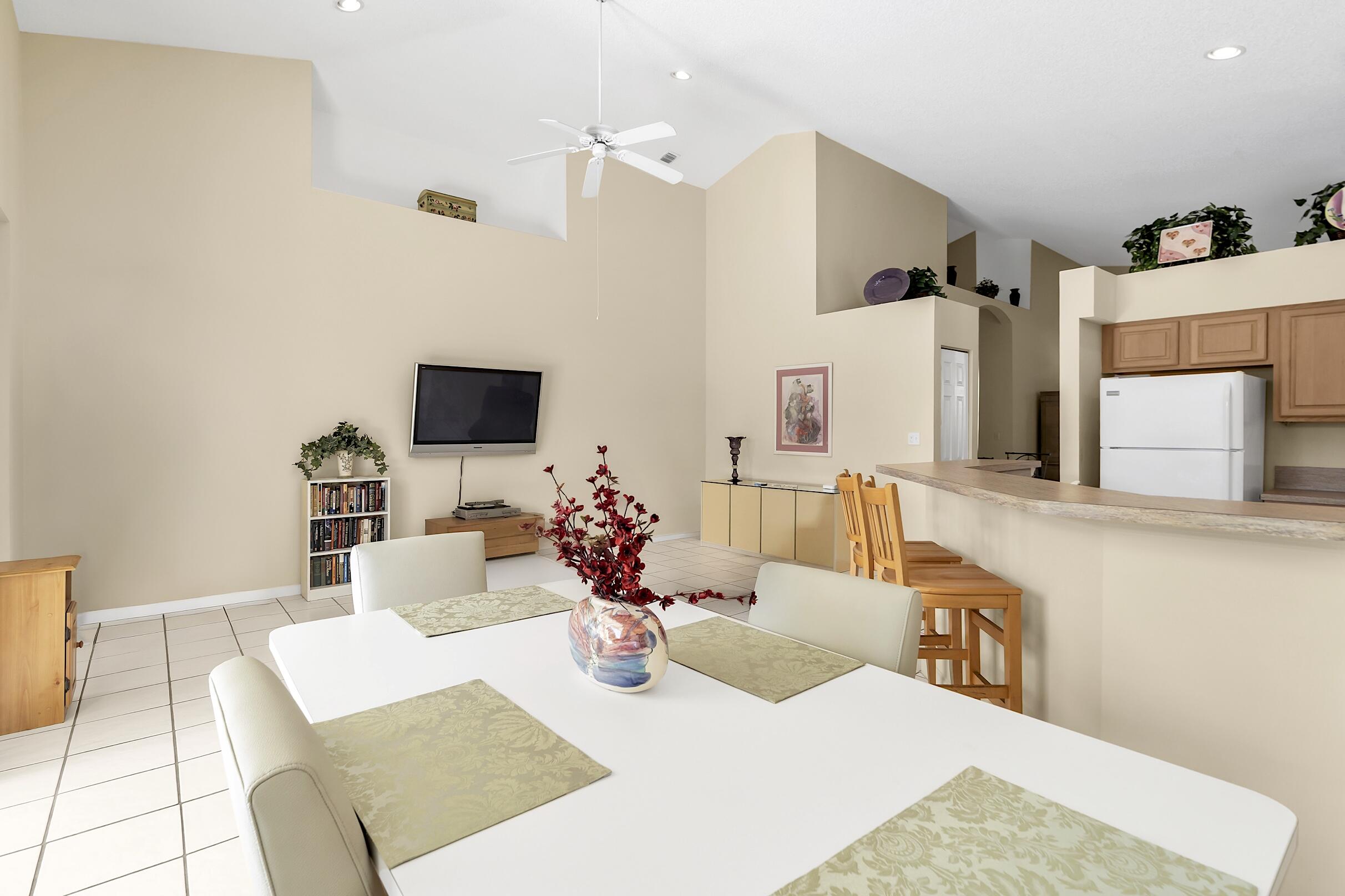 7507 Eagle Point Drive Delray Beach, FL 33446 - Photo 21 of 49 a living room with furniture and a flat screen tv