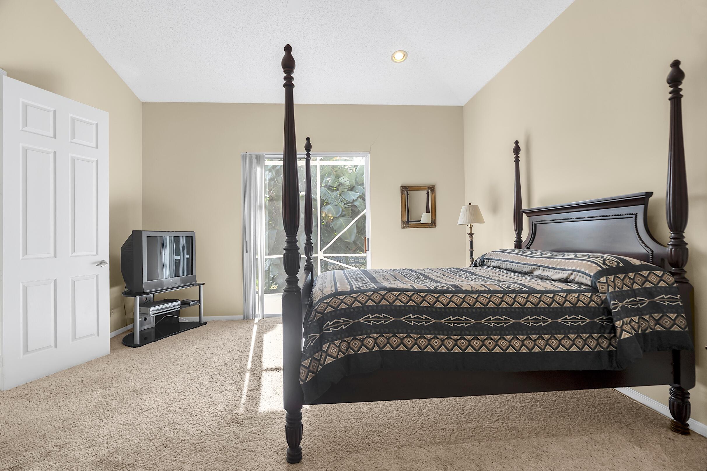 7507 Eagle Point Drive Delray Beach, FL 33446 - Photo 25 of 49 a bedroom with a bed dresser and a view of living room