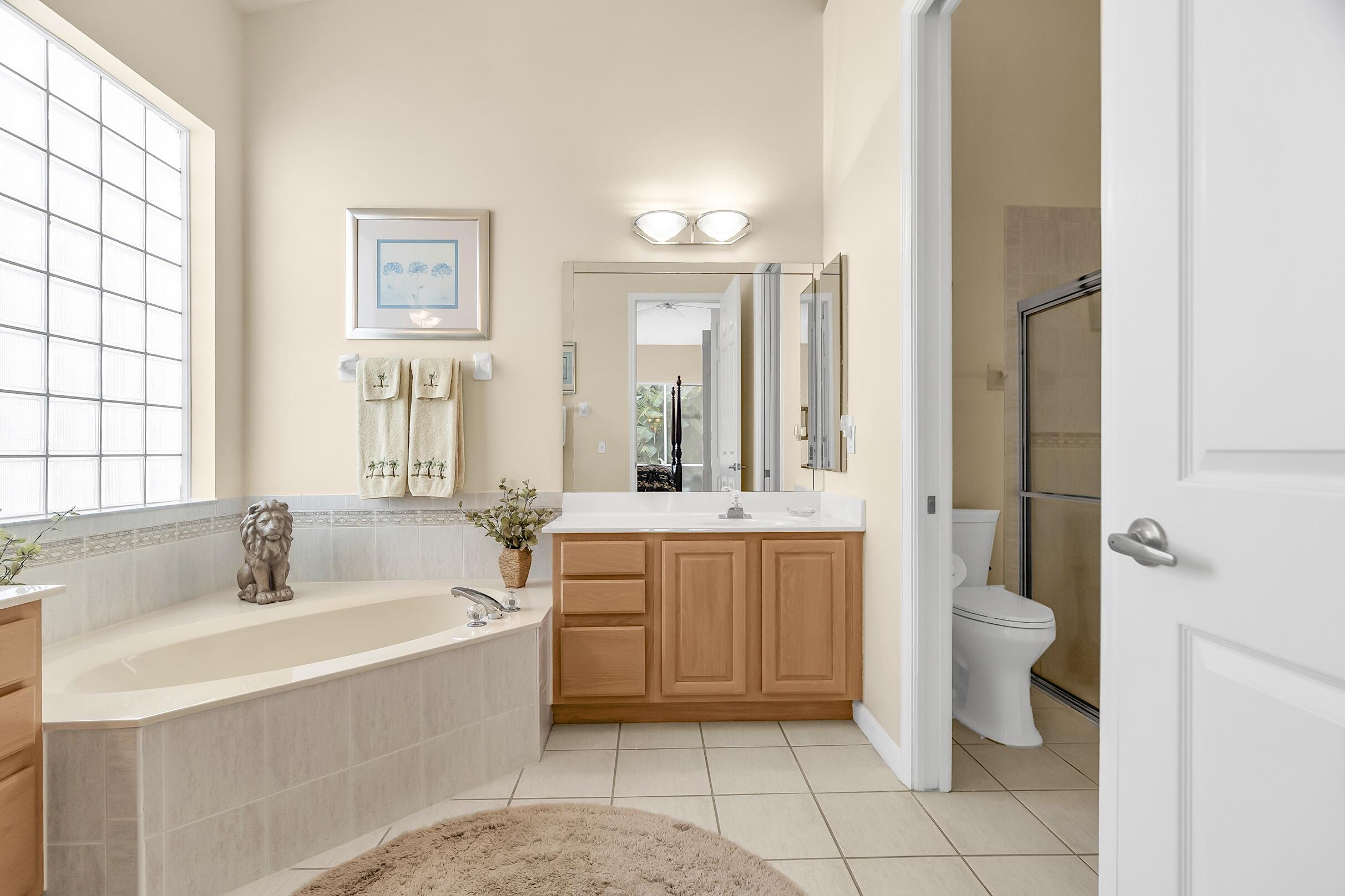 7507 Eagle Point Drive Delray Beach, FL 33446 - Photo 28 of 49 a bathroom with a sink a toilet and tub