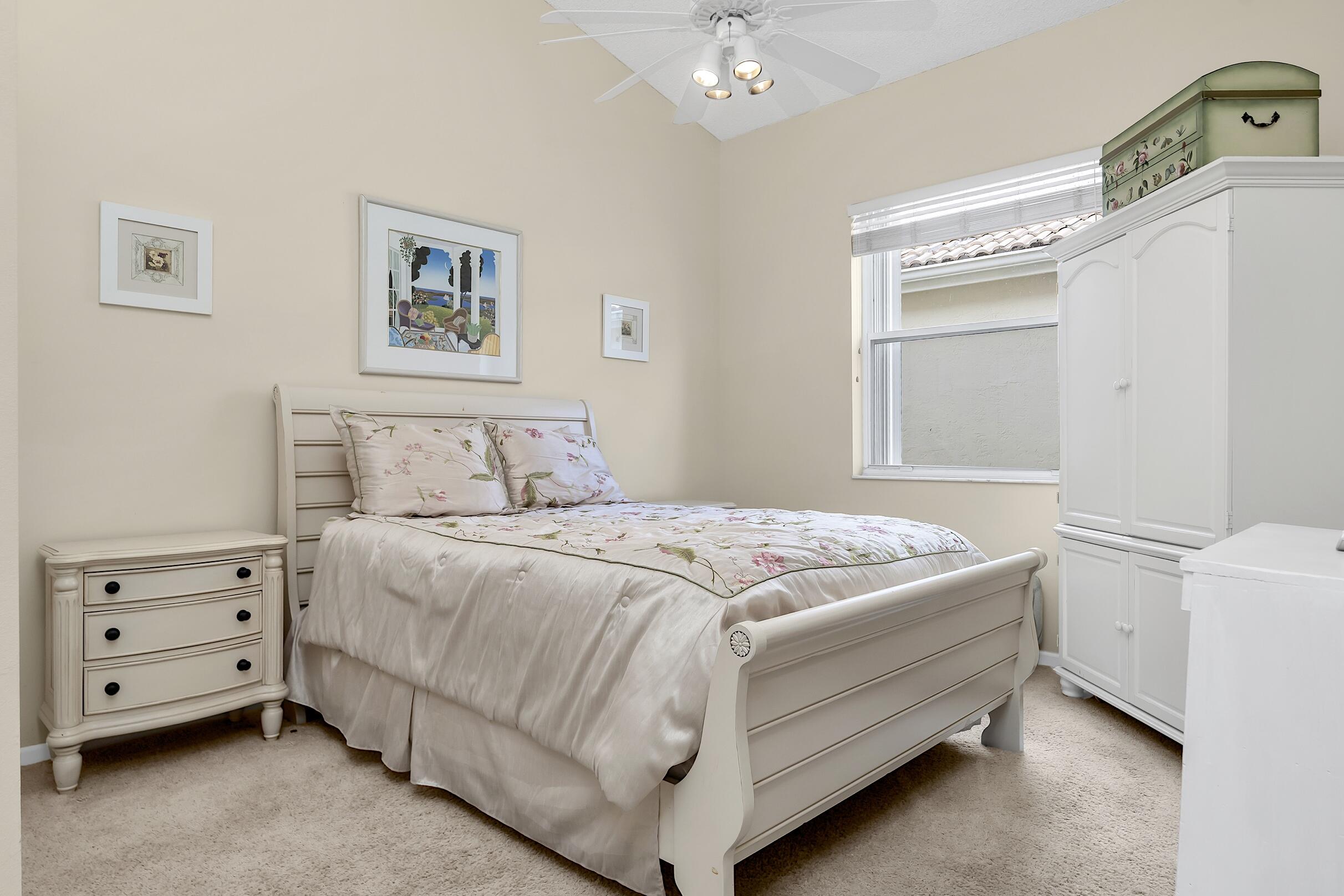 7507 Eagle Point Drive Delray Beach, FL 33446 - Photo 32 of 49 a bedroom with a bed and a window