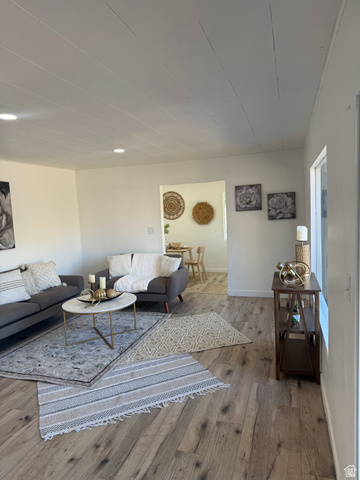 47 B Street Helper, UT 84526 - Photo 6 of 19 Spacious living area featuring wood-finish flooring, recessed lighting, and a neutral color palette