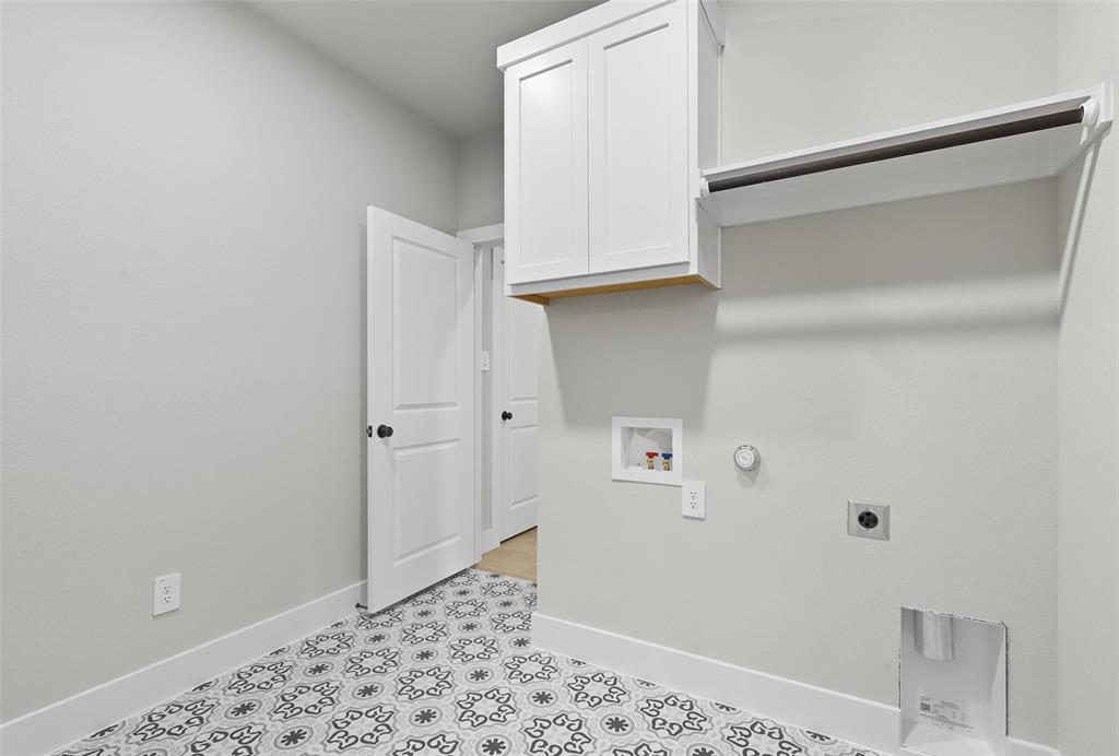 1005 Ronnie Court Springtown, TX 76082 - Photo 15 of 27 Laundry area featuring hookup for a gas dryer, cabinet space, hookup for an electric dryer, and washer hookup