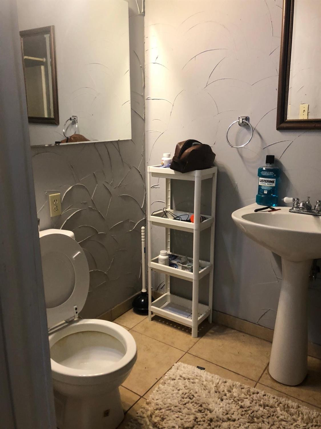 2604 44th Street Lubbock, TX 79413 - Photo 7 of 10 a bathroom with a sink toilet and mirror