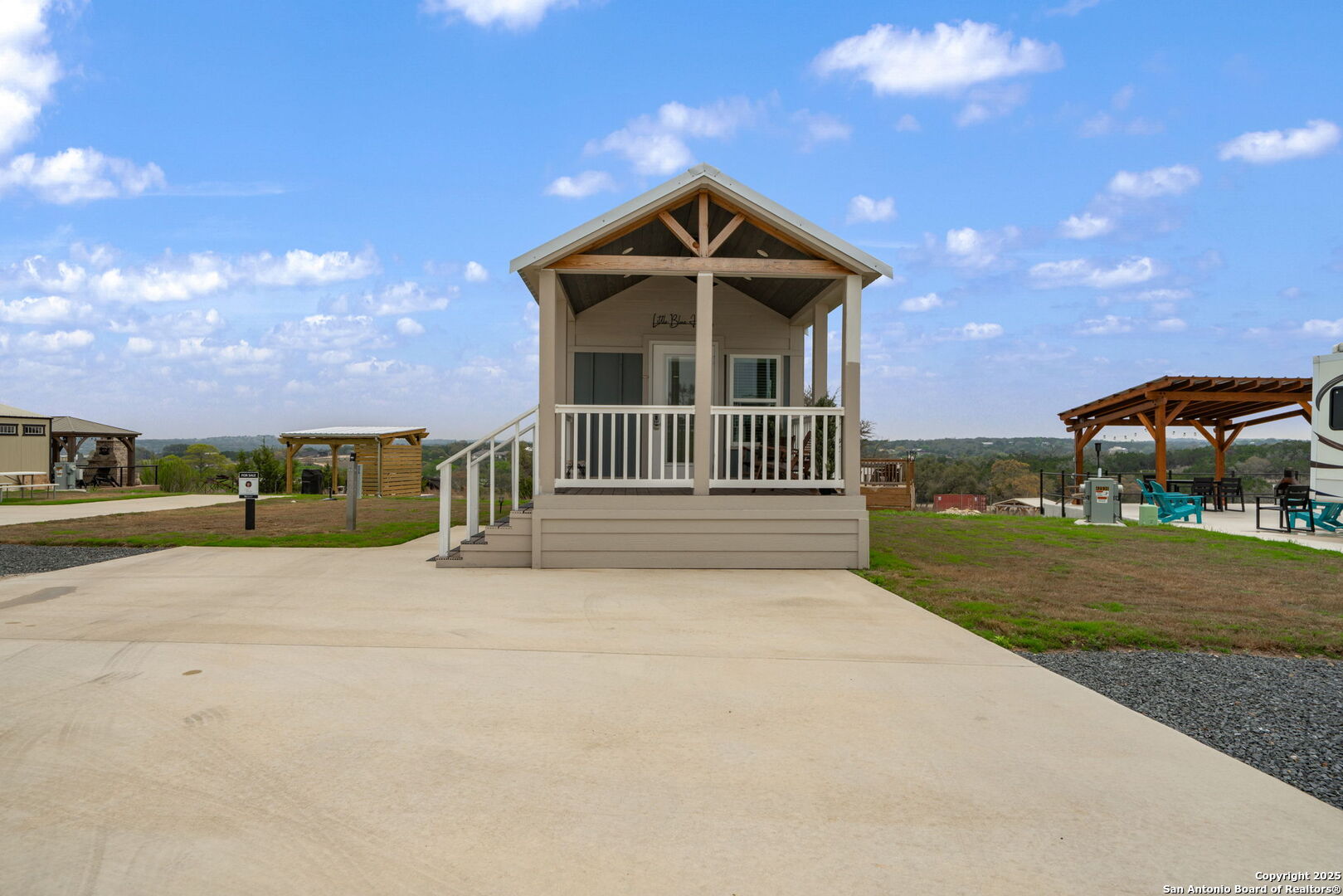 5386 Ranch Road 1376, Unit 172 Fredericksburg, TX 78624 - Photo 2 of 34 a front view of a house with a yard