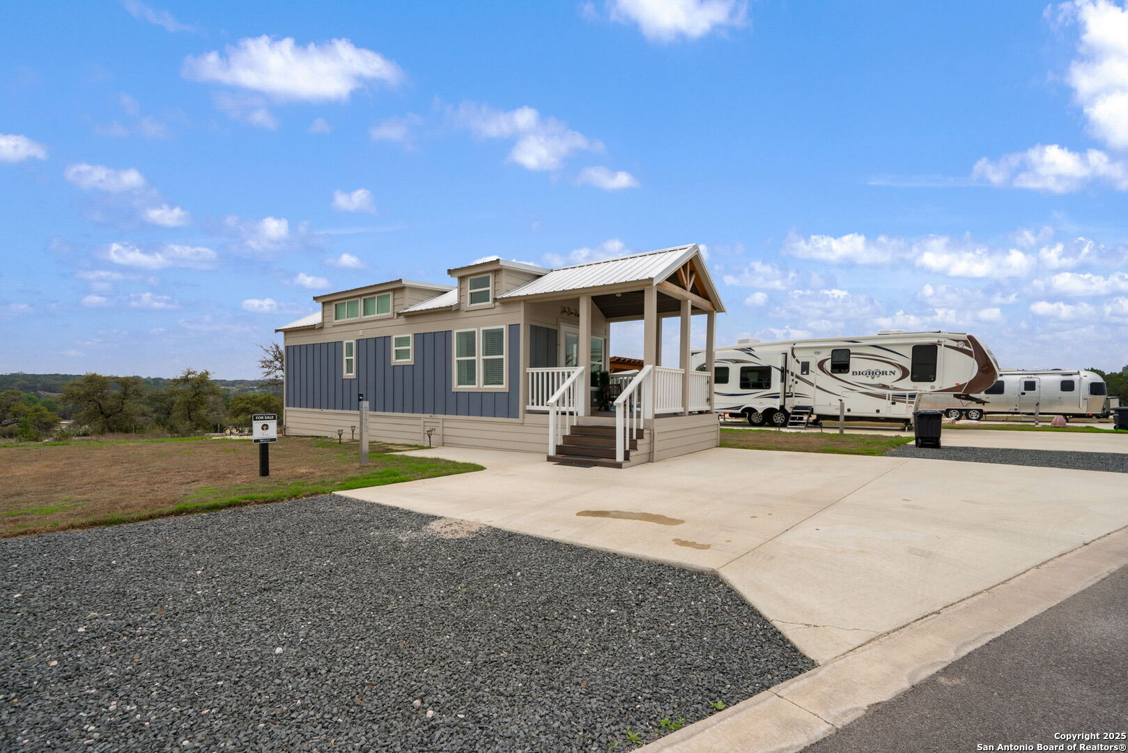 5386 Ranch Road 1376, Unit 172 Fredericksburg, TX 78624 - Photo 4 of 34 a front view of a house with a yard and garage