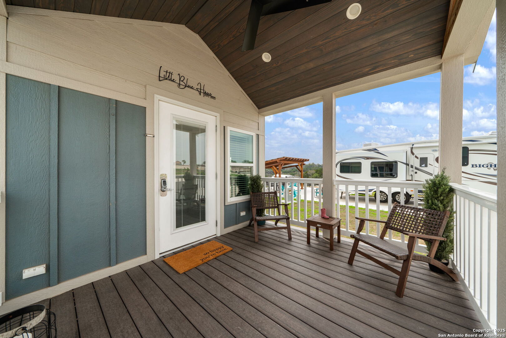 5386 Ranch Road 1376, Unit 172 Fredericksburg, TX 78624 - Photo 5 of 34 a balcony with furniture and wooden floor