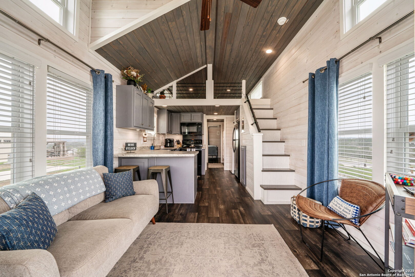 5386 Ranch Road 1376, Unit 172 Fredericksburg, TX 78624 - Photo 7 of 34 a living room with furniture a fireplace and large windows