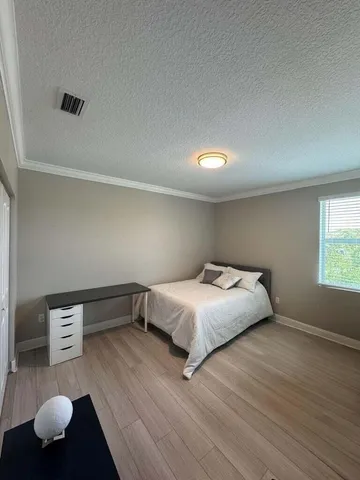 a bedroom with a bed and window