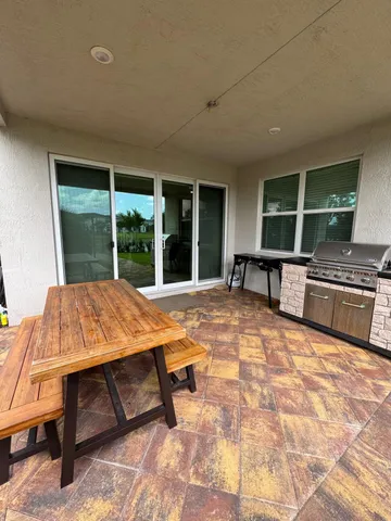 a swimming pool with outdoor seating and yard
